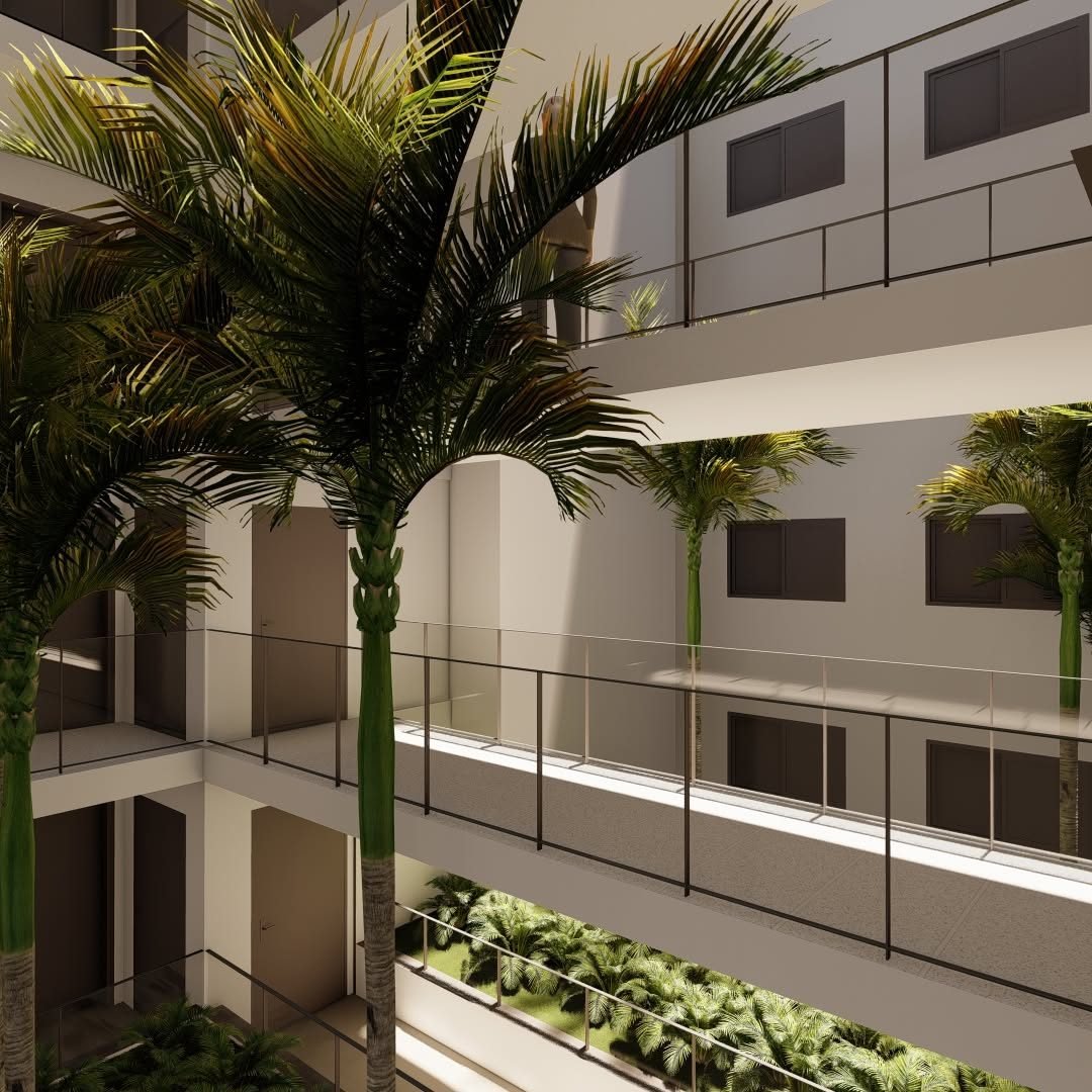 Perspective du patio intérieur planté de palmiers et des coursives